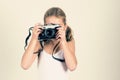 pretty young girl holding old camera, girl make a pretence of taking photos