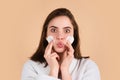 Pretty young girl with daily morning skincare procedures, cleansing face skin with natural lotion tonic using cotton Royalty Free Stock Photo