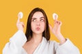 Pretty young girl with daily morning skincare procedures, cleansing face skin with natural lotion tonic using cotton Royalty Free Stock Photo