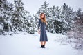 Pretty young girl posing in the winter in cold forest Royalty Free Stock Photo