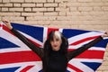 Pretty young girl in punk style with the london flag on her shoulders celebrating some national event. Patriotic concept Royalty Free Stock Photo