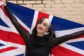 Pretty young girl in punk style with the london flag on her shoulders celebrating some national event. Patriotic concept Royalty Free Stock Photo