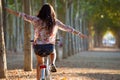 Pretty young girl riding bike in a forest. Royalty Free Stock Photo