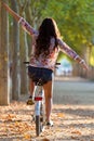 Pretty young girl riding bike in a forest. Royalty Free Stock Photo