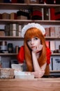 Pretty young girl servant costume portrait dressed in red in the shop