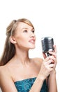 Pretty young girl singing into retro microphone Royalty Free Stock Photo