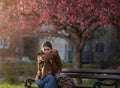 Girl coughing in park in spring