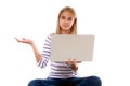 Pretty young girl sitting on the floor with crossed legs and showing something on the palm of her hand,isolated Royalty Free Stock Photo