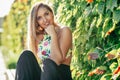 Pretty young girl sitting on urban bench