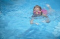 Pretty young girl swimming outdoors in a pool Royalty Free Stock Photo