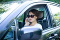 Pretty young girl talking on the phone driving a car Royalty Free Stock Photo