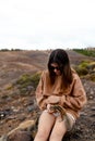 pretty young girl or teenager in nature domesticating a squirrel