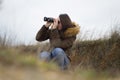 Pretty young girl / woman watching out by ornitology telescope t