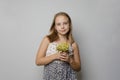 Pretty young girl with yellow flower in her hand on white background Royalty Free Stock Photo