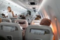 Pretty, young happy woman aboard an airplane