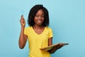 Pretty young hapy beautiful woman holding textbook and blue market notebook Royalty Free Stock Photo