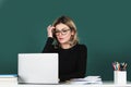 Pretty young high school or college teacher on the chalkboard. Young caucasian female teacher portrait with blackboard Royalty Free Stock Photo