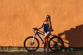 Pretty young hipster blonde girl posing with sport bicycle Royalty Free Stock Photo