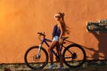 Pretty young hipster blonde girl posing with sport bicycle Royalty Free Stock Photo