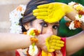 Pretty young indian girl showing colourful palm and celebrating Holi with colour splash, popular hindu festival celebrated across Royalty Free Stock Photo