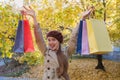 Pretty young lady enjoys good shopping. Multicolored shopping bags. Sale Fall