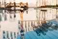 Pretty young lady, skiny girl in the midle of big nice pool near luxury resort hotel. Spending summer time, holiday, spa Royalty Free Stock Photo