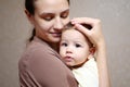 Pretty young mother holding her newborn baby boy. close up Royalty Free Stock Photo