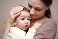 Pretty young mother holding her newborn baby boy. close up Royalty Free Stock Photo