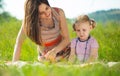 Pretty young mother reading book to her little daughter Royalty Free Stock Photo