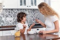 Mother and children having breakfast at home Royalty Free Stock Photo