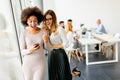 Pretty young women with moble phone in the office