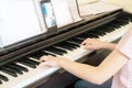 Pretty young musician playing classic digital piano at home during online class at home, social distance during quarantine, self-