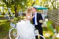 Pretty young newlyweds with bike