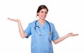 Pretty young nurse standing holding palms out Royalty Free Stock Photo