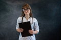 Pretty young nurse wear uniform holding stethoscope clipboard with documents isolated Royalty Free Stock Photo