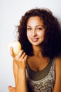 Pretty young real tenage girl eating apple close up smiling