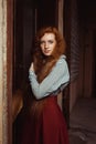 Pretty young red haired model wearing white striped shirt and re Royalty Free Stock Photo