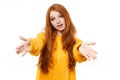 Pretty young redhead woman girl in casual yellow hoodie posing isolated on white background studio portrait. People Royalty Free Stock Photo