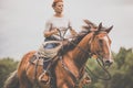 Pretty, young, redhead woman with her lovely horse