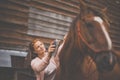 Pretty, young, redhead woman with her lovely horse