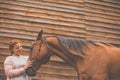 Pretty, young, redhead woman with her lovely horse