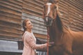 Pretty, young, redhead woman with her lovely horse Royalty Free Stock Photo