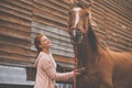 Pretty, young, redhead woman with her lovely horse Royalty Free Stock Photo