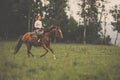 Pretty, young, redhead woman with her lovely horse