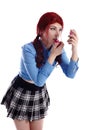 Pretty young schoolgirl putting on makeup