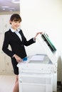 Pretty young secretary using photocopy machine Royalty Free Stock Photo