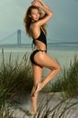 Pretty young woman in black swimsuit posing outdoor in summer on the beach. Royalty Free Stock Photo