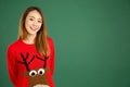 Pretty young singaporean girl wearing Christmas jumper and smiling Royalty Free Stock Photo