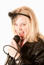 Pretty young singer or comedian with microphone Royalty Free Stock Photo