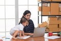 Pretty young single mom working at home on a laptop computer, and baby daughter need her attention. Mother play on laptop with Royalty Free Stock Photo